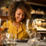 A woman enjoys her dinner at a restaurant in Whistler.