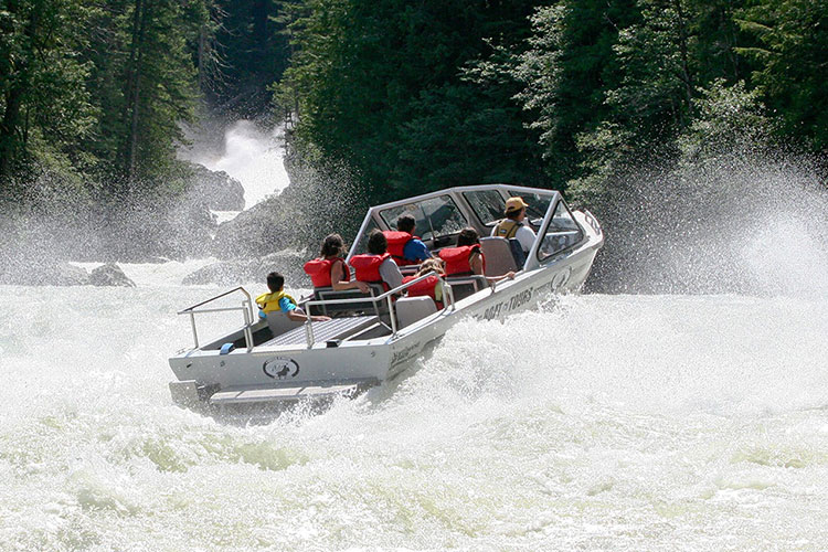 People ride through white water rapids with Whistler Jet Boating.