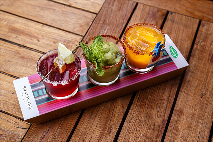 Three colourful margaritas sit in a line, part of the Margarita Flight at the Four Seasons Whistler.