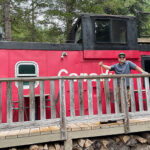 Allan Crawford, owner of Canadian Wilderness Adventures poses by the caboose at their base in the Callaghan Valley.