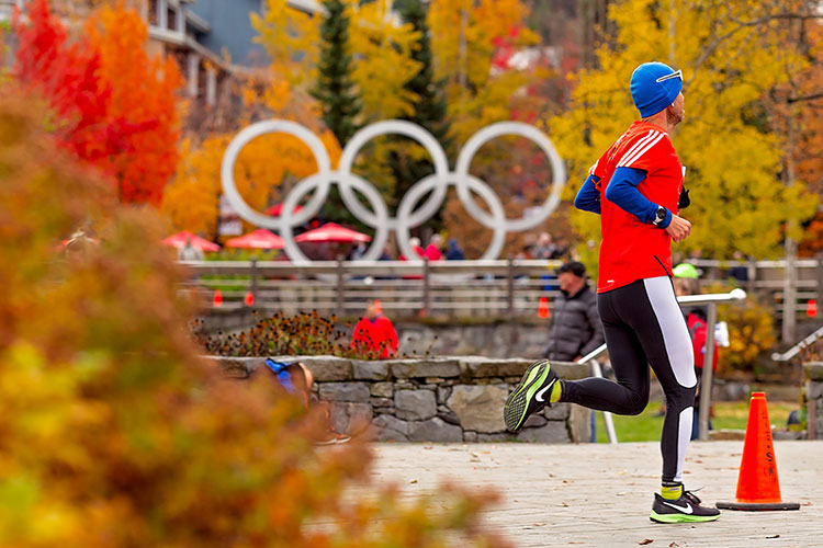 A runner comes into Whistler Village at the end of the Whistler 50 Relay and Ultra amidst the fall colours.