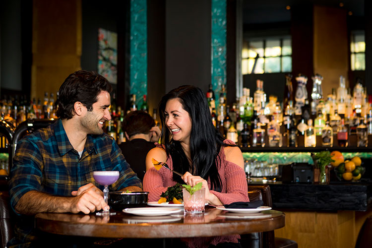 A couple eat dinner at the Raven Room in Whistler.