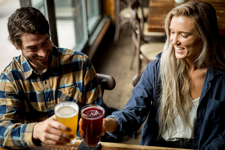 A couple drink craft beer in Whistler.