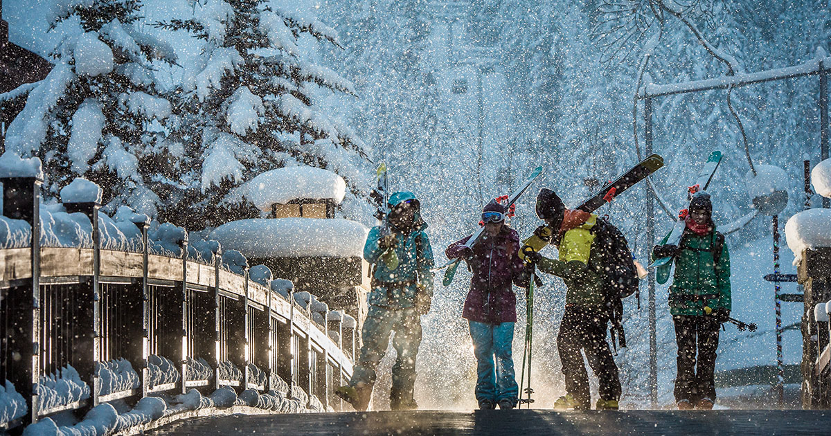 A group of skiers walk away from the Creekside Gondola in Whistler.