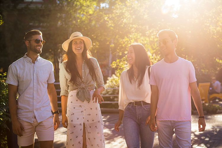 A group of friends stroll through Whistler Village in the summer.