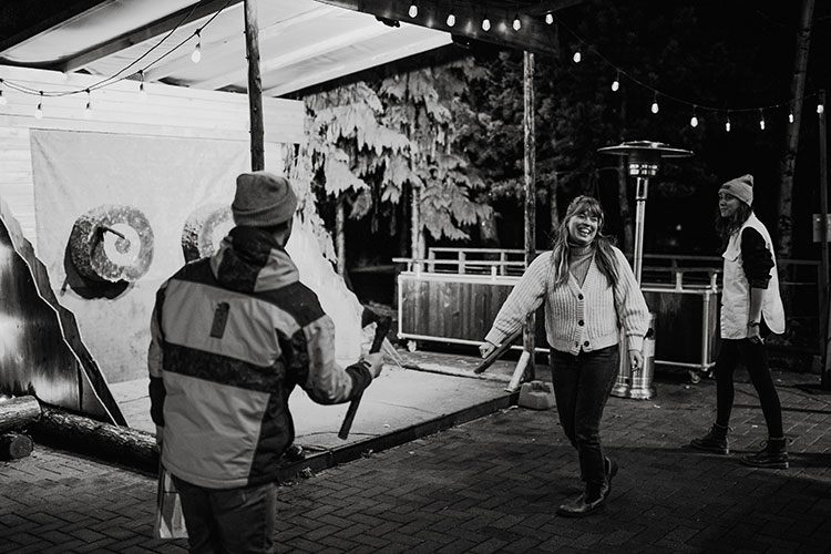 A group of women throw axes at Whistler Racket Club.