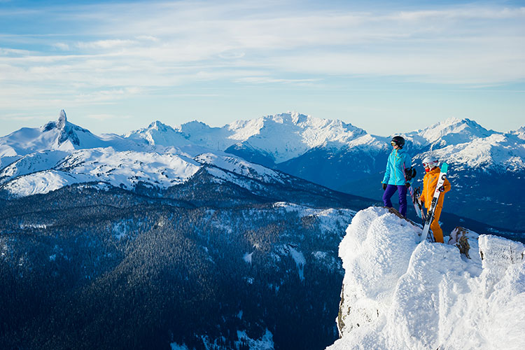 Skiers look out over the Coast Mountain towards Black Tusk.