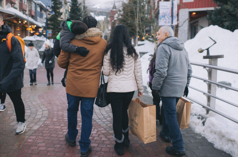A family shops along the Village Stroll in Whistler.