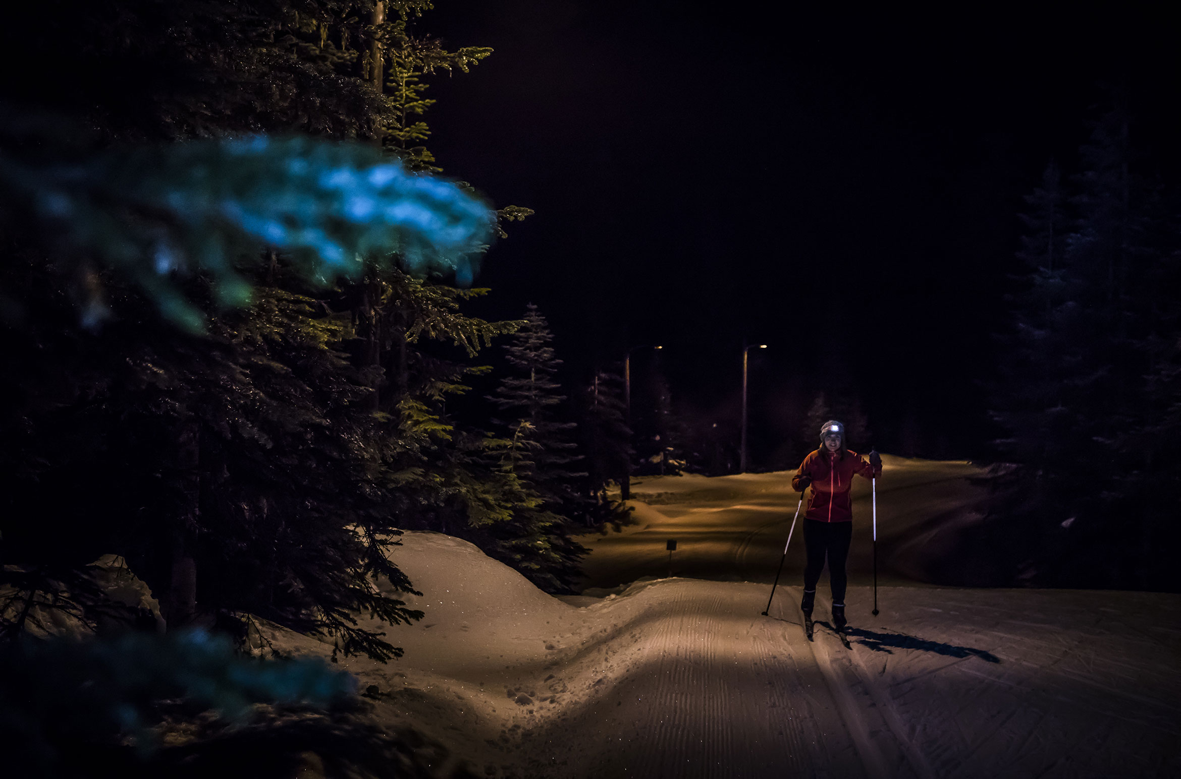 A cross-country skier glides around Lost Lake in the dark.