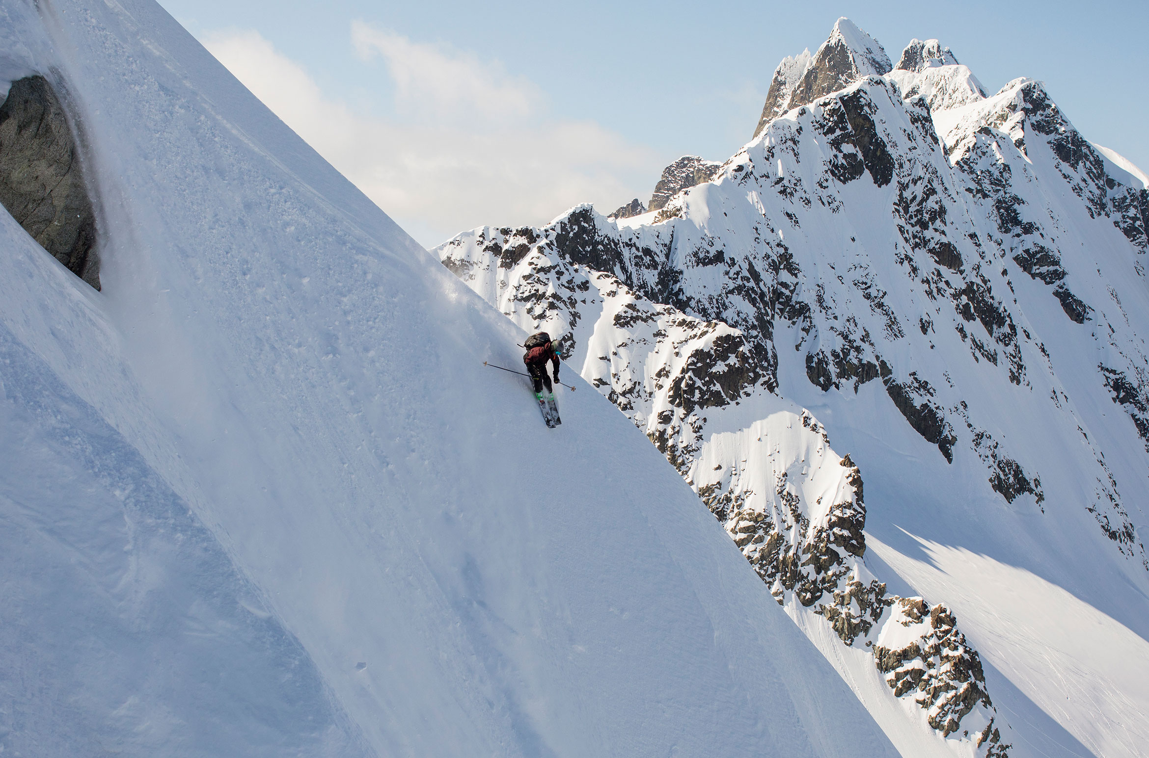 A skier skis a steep line in the Whistler backcountry.