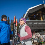 Two cross-country skiers get ready to go outside the Lost Lake PassivHaus in Whistler.