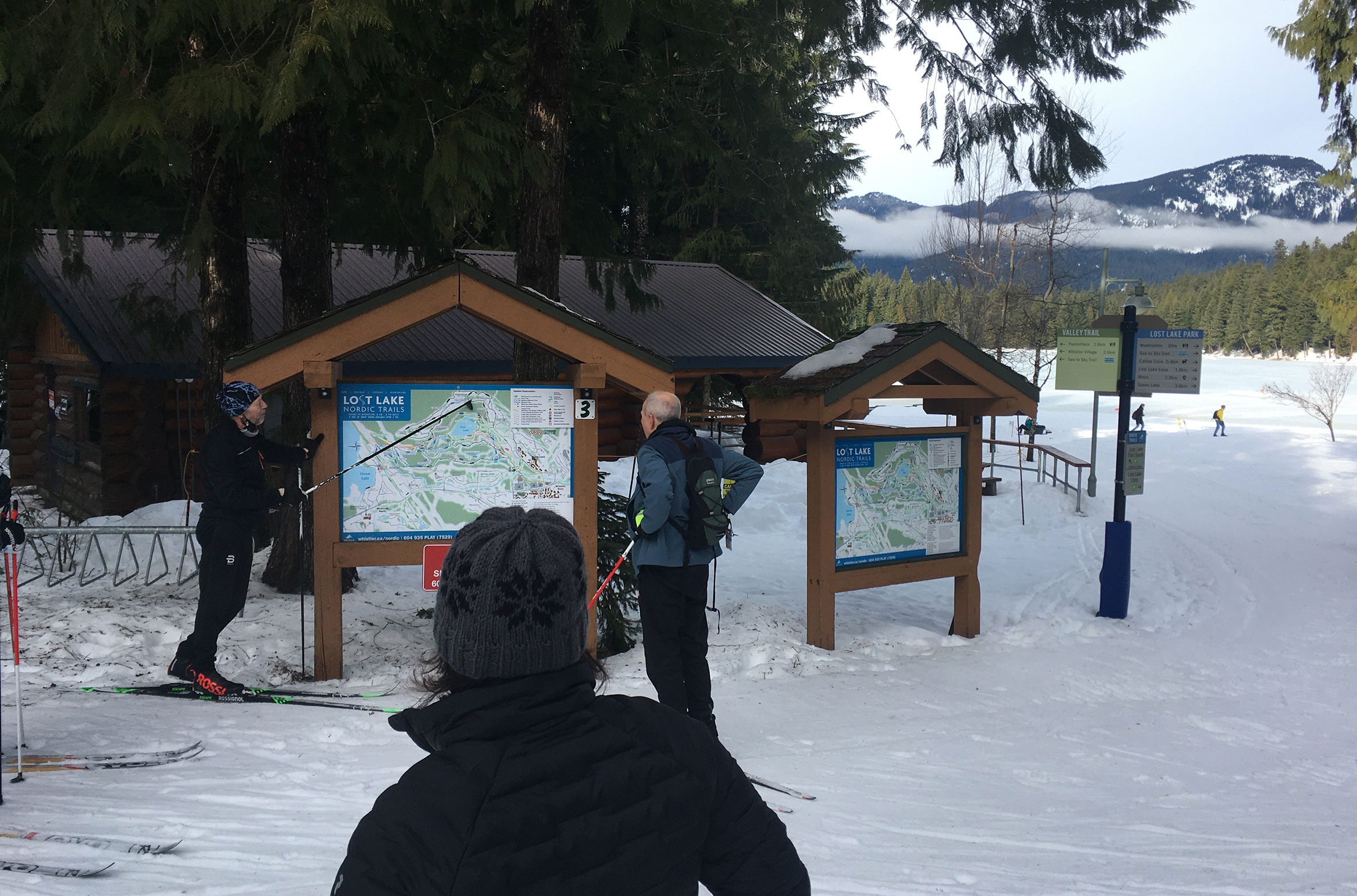 Cross-country skiers look at the map for Lost Lake in Whistler.