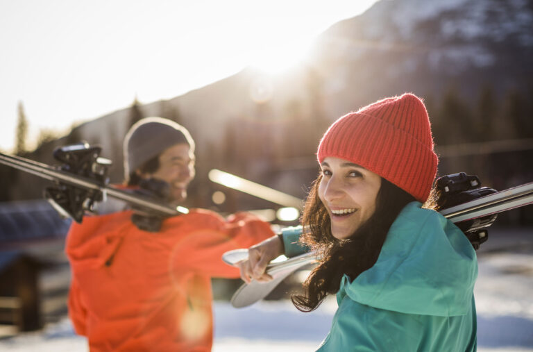 A couple head to the ski slopes in the spring sunshine.