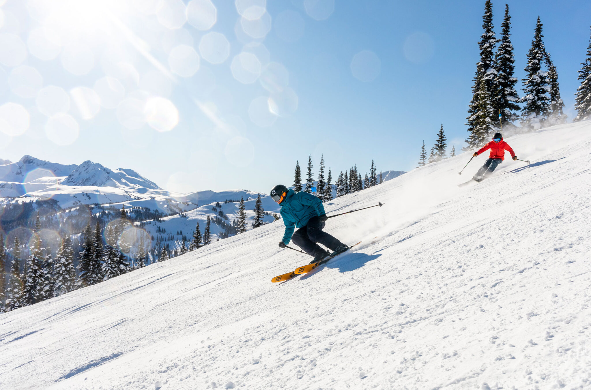 Skiers enjoy the sunshine as they ski down the slopes on Whistler Blackcomb.