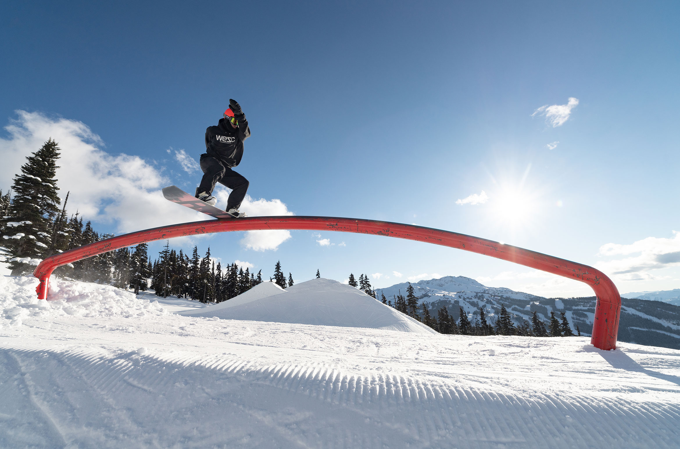 A snowboarder hits a rail in the park on Whistler Blackcomb.