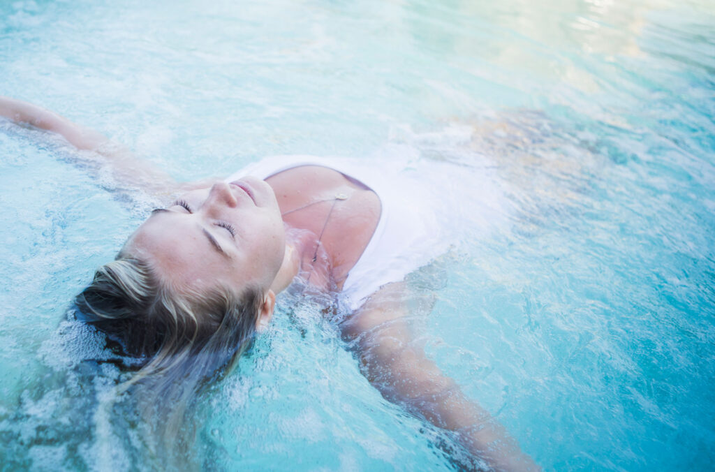 A woman floats in a hot pool at the Scandinave Spa Whistler.