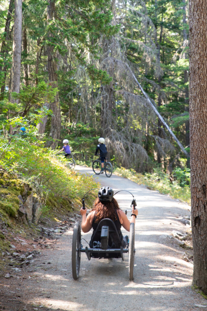 Codi riding along the double track biking and hiking trails in Whistler.