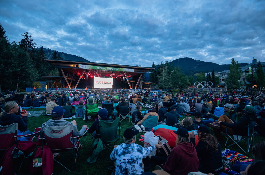 People gather on the lawns of Olympic Plaza in Whistler to watch the Deep Summer event, part of Crankwrox Whistler.