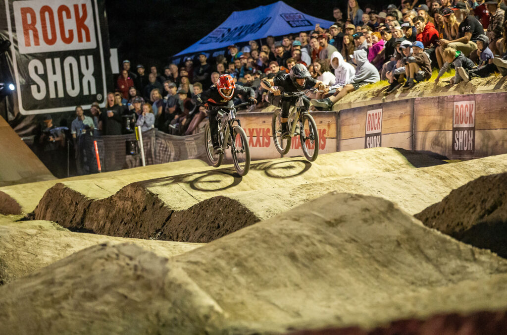 Two bikers compete head to head during the Pump Track event, part of Crankworx Whistler.
