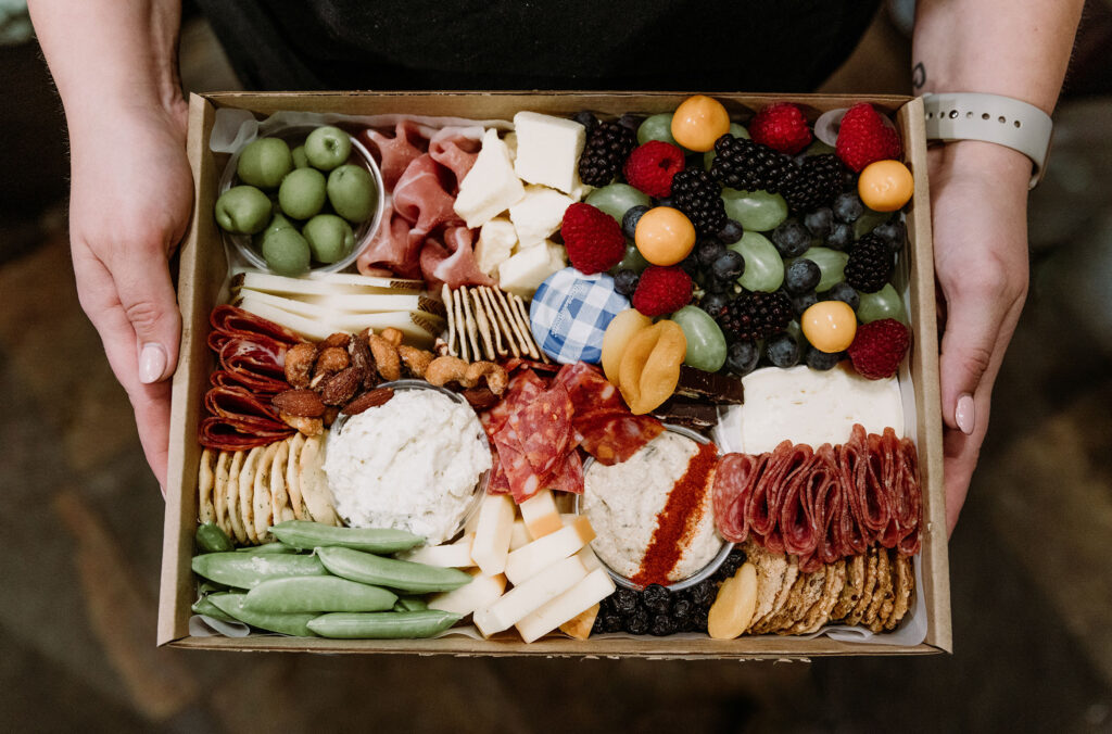 A stunning cheese, charcuterie and fruit box by Picnic Whistler makes it easy to do adventure dining.