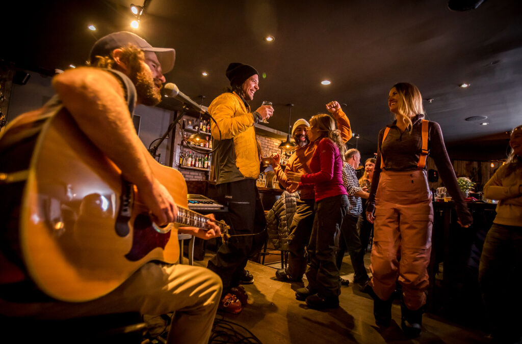 People dance to live music enjoying the vibrant apres scene.