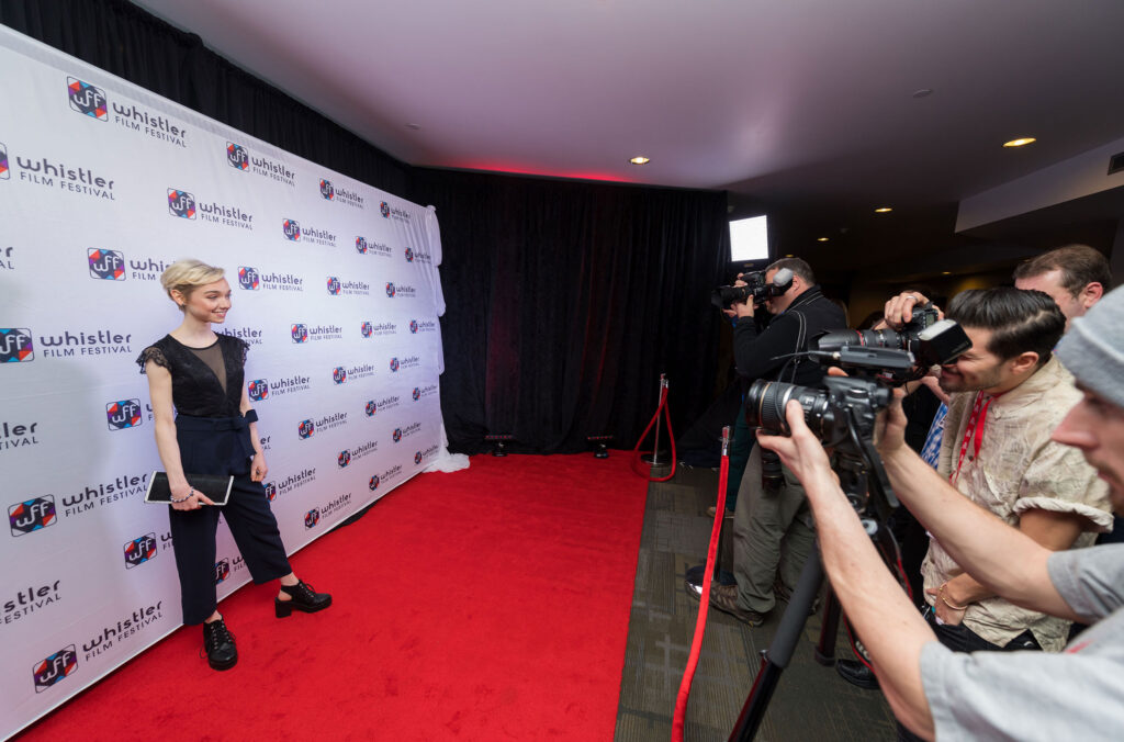 An actor gets their photo taken by photographers at the Whistler Film Festival.