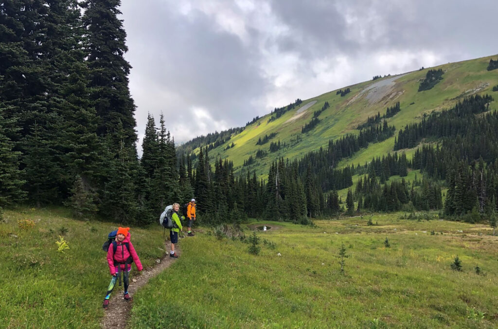 Alexander and his family follow the trail to Russet Lake through lush, green mountain pastures.