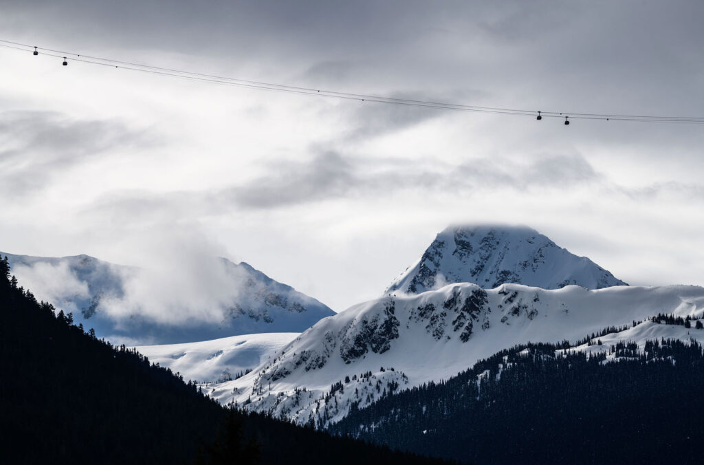 A shot of Whistler Blackcomb with the clouds rolling by and the PEAK 2 PEAK Gondola in view.