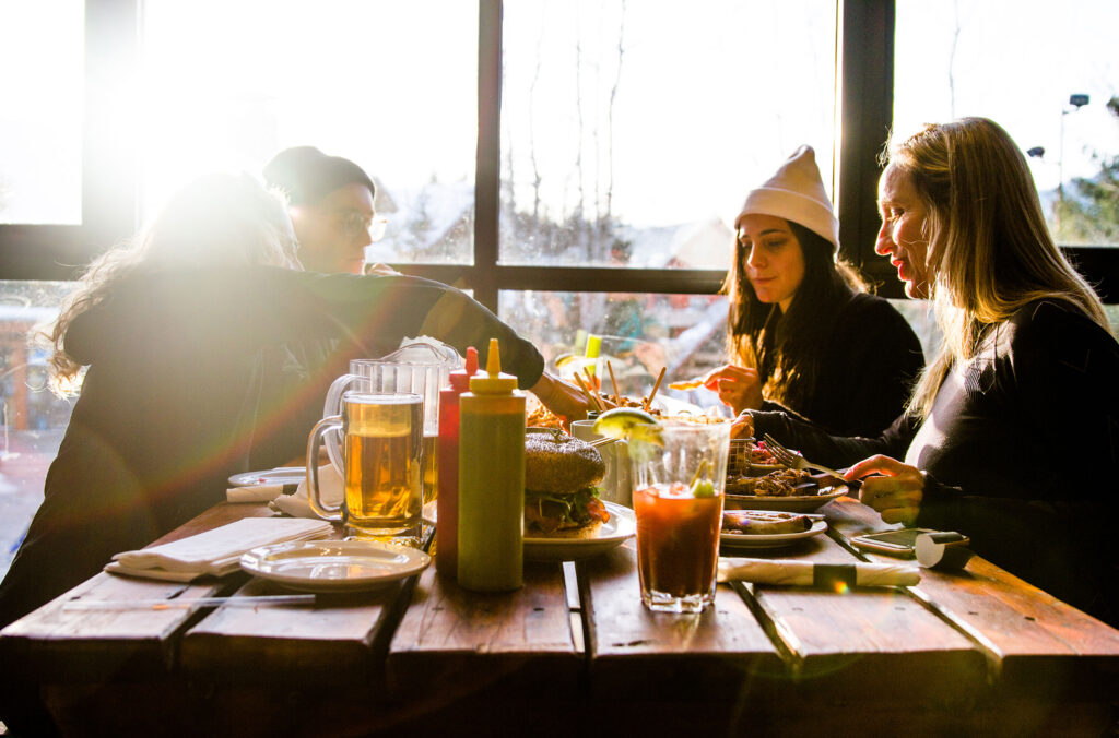 A group of skiers tuck into lunch on Whistler Blackcomb.