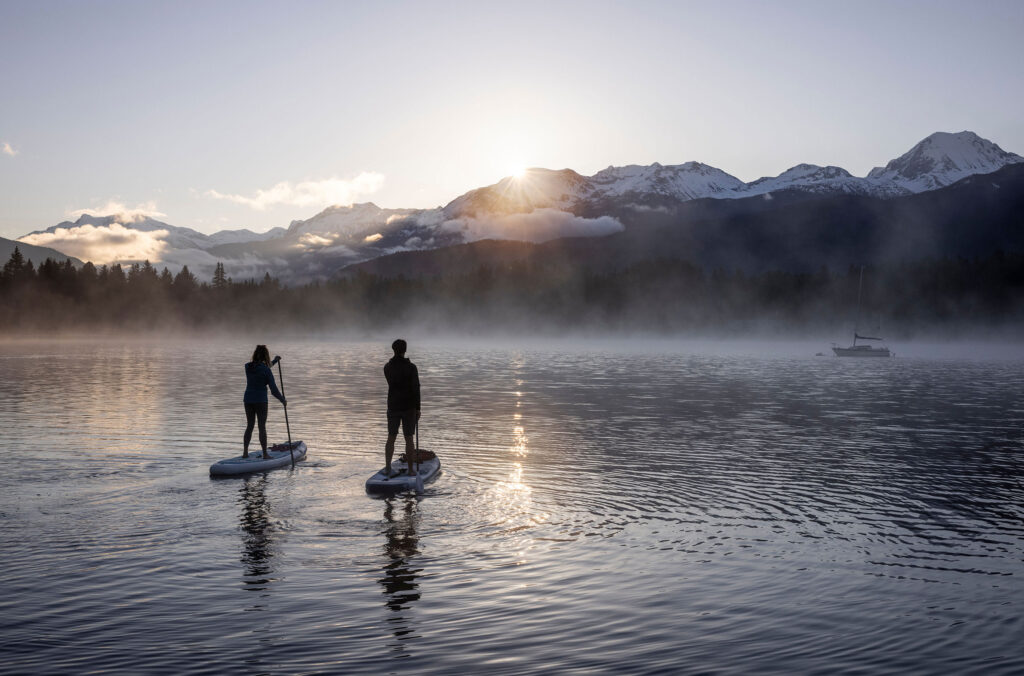 Two paddleboarders enjoy the morning calm on a fall day in Whistler.