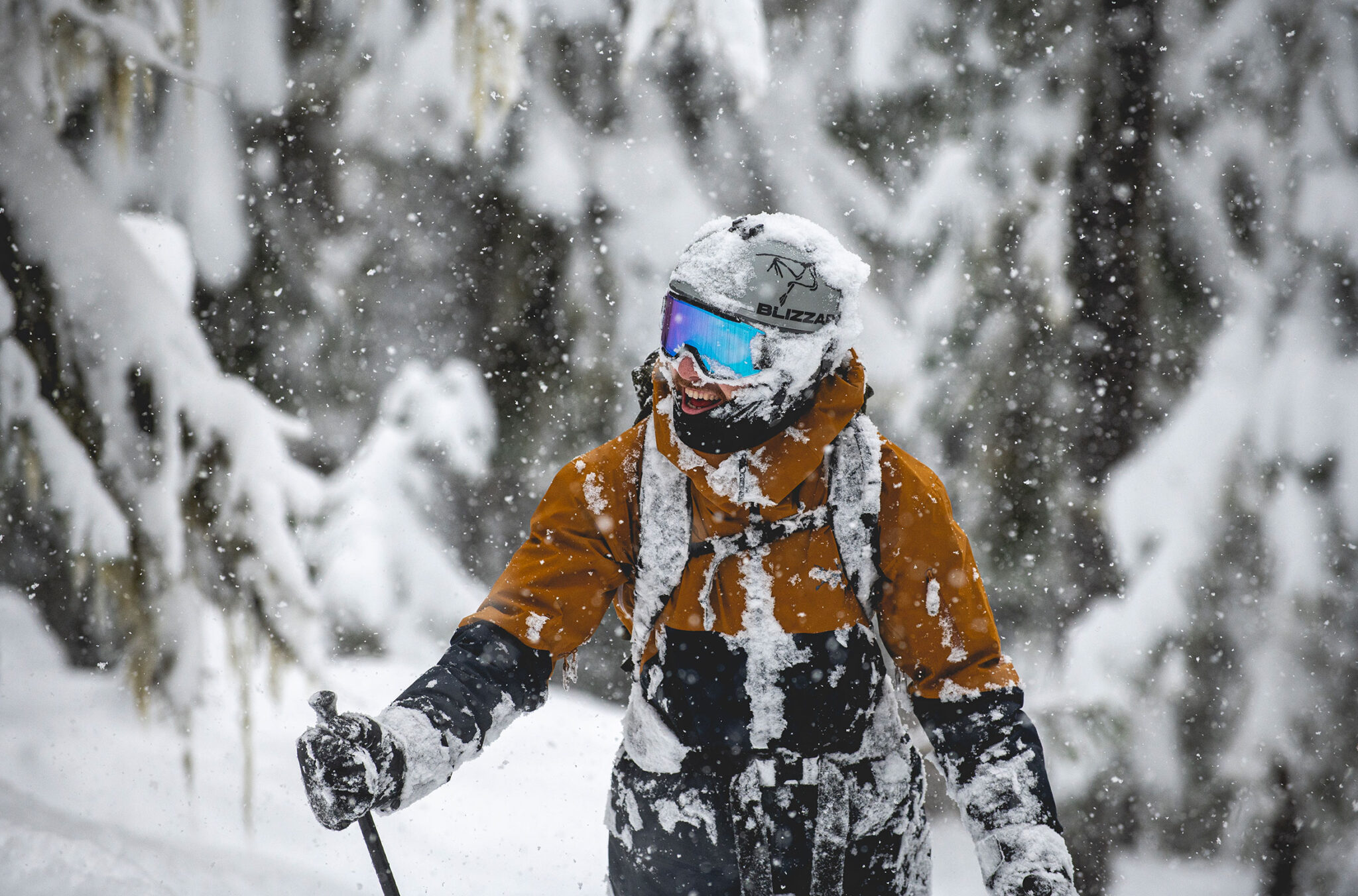 A skier is covered in snow as they enjoy the powder while skiing on Whistler Blackcomb.