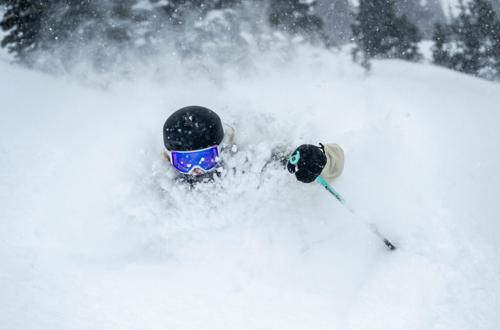 A skier charges through deep powder on a snowy run on Whistler Blackcomb.