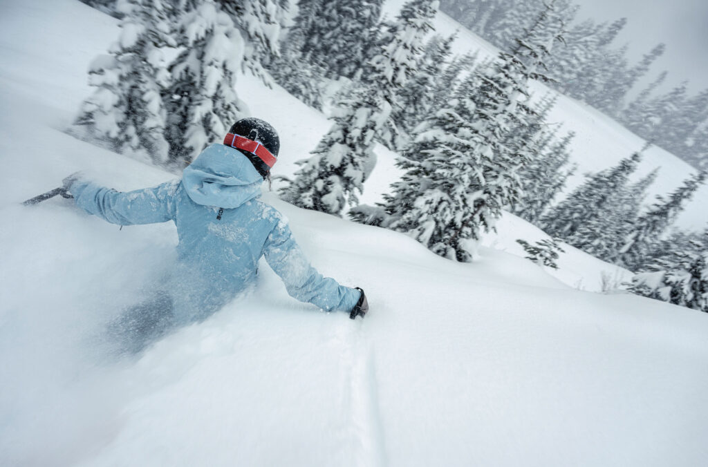 A skier sinks into deep snow as they ski Whistler Blackcomb.