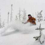 A snowboarder ploughs through powder on the slopes in Whistler.