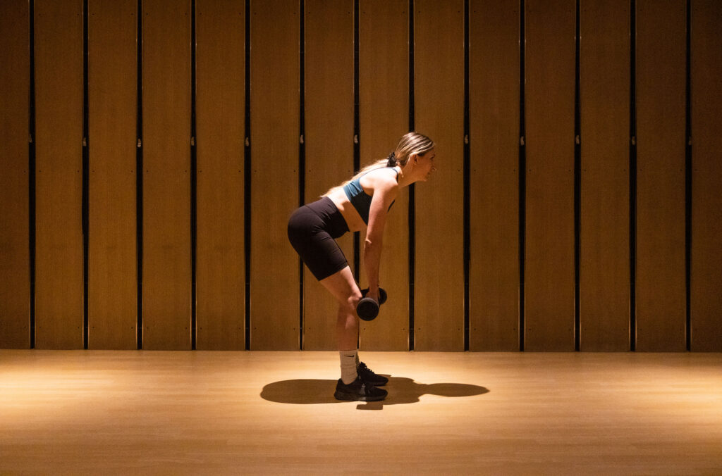 Whistler local and athlete, Hailey Elise performs a dumbbell deadlift.