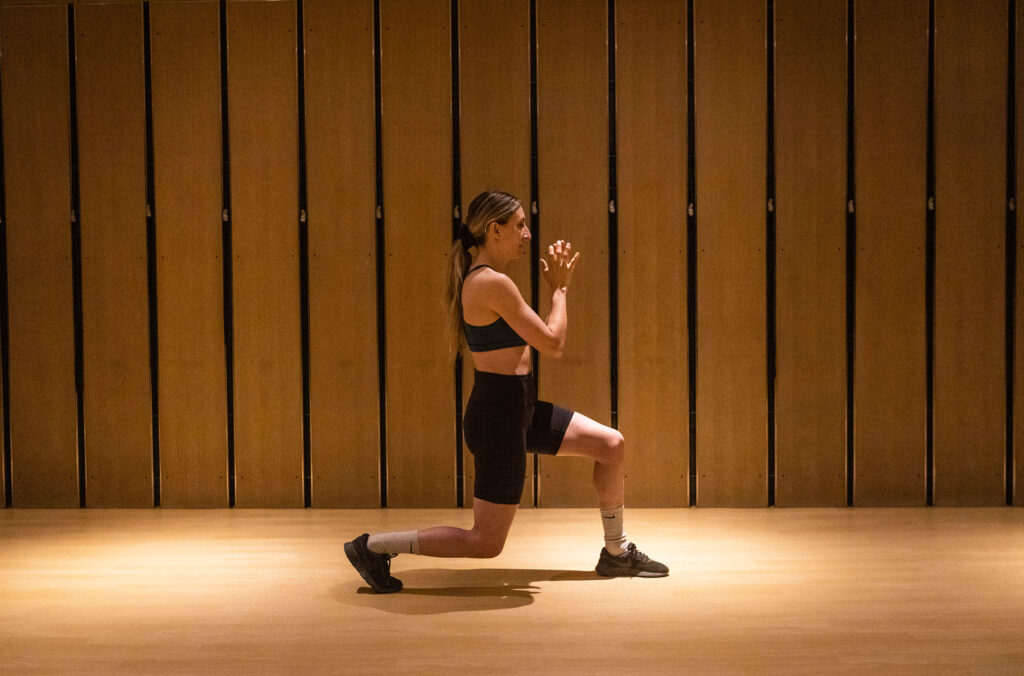 Whistler local and athlete, Hailey Elise performs a forward lunge.