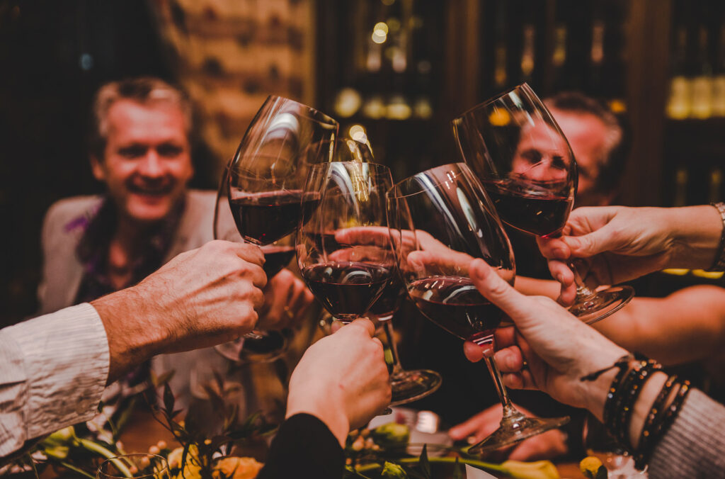 A group say cheers over a glass of wine at Cornucopia Whistler.