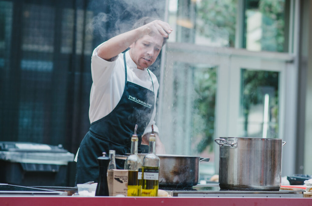 A chef demonstrates his dished in front of an audience at one of the Culinary Stages at Cornucopia Whistler.