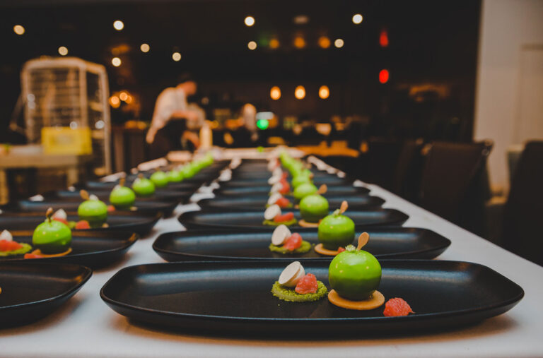 Beautifully plated food is lined up in preparation for a Cornucopia Whistler event.