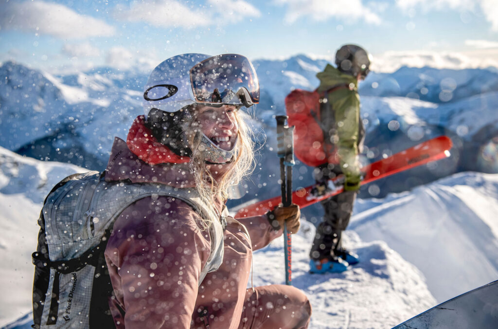 Two snowboarders take in the views at the top of Whistler Blackcomb.