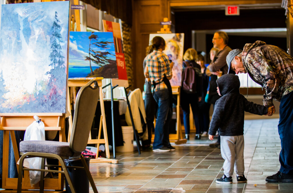 Artists work on their Tree of Hope paintings at the Fairmont Chateau Whistler.