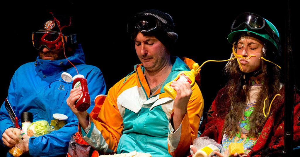 Ira Pettle squirting two fellow chairlift riders with sauce in one of his comedy performances in Whistler.