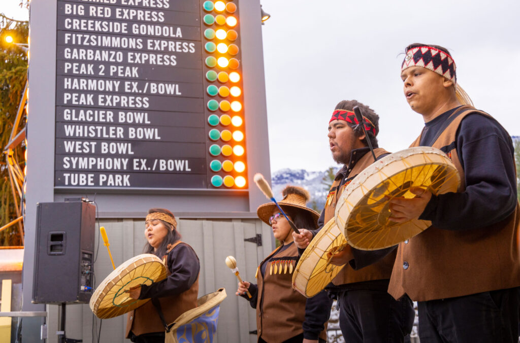 Cultural Ambassadors from the SLCC welcome skiers to the slopes on Whistler Blackcomb's opening day.