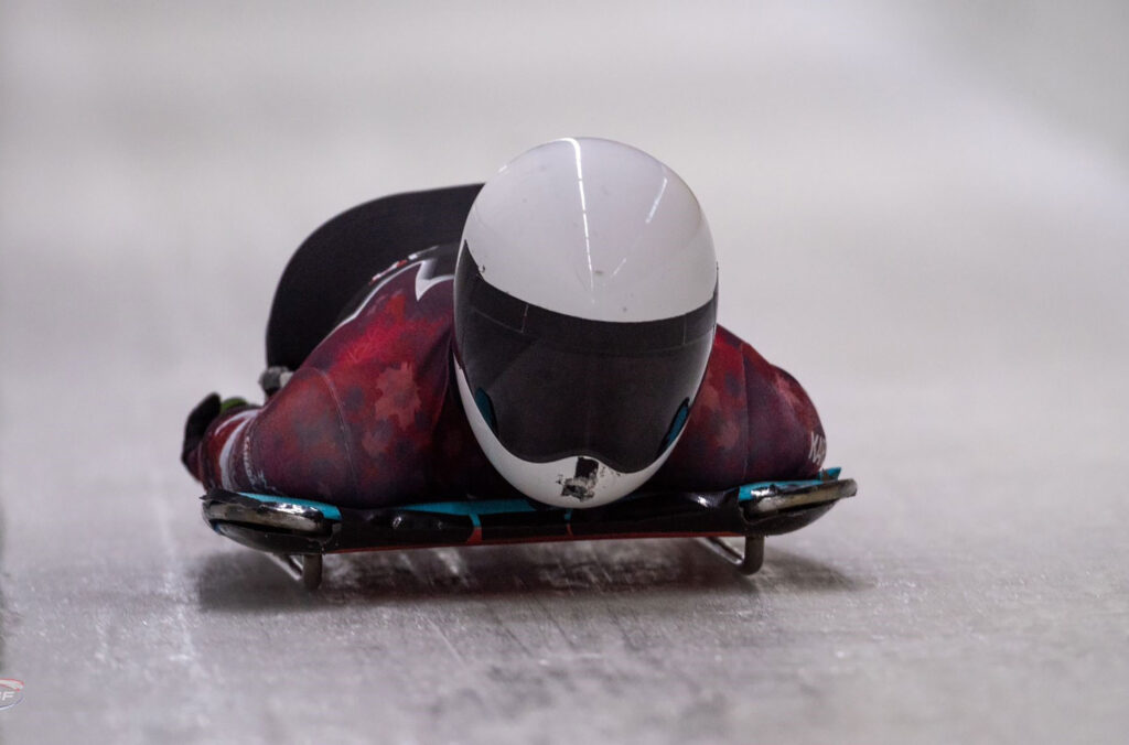 A close up shot of skeleton athlete, Payton Spence makes her way down the Whistler Sliding Centre's Olympic track.
