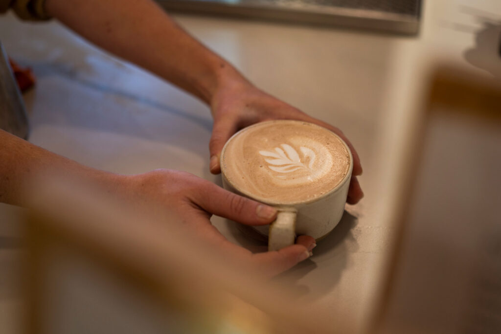 A mug of hot chocolate is passed across the counter at ecologyst in Whistler.