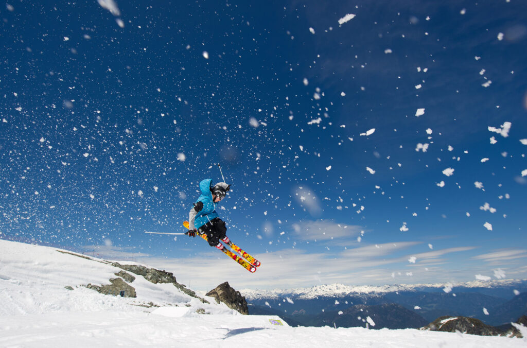A skier finds a jump on the side of a slope on Whistler Blackcomb.