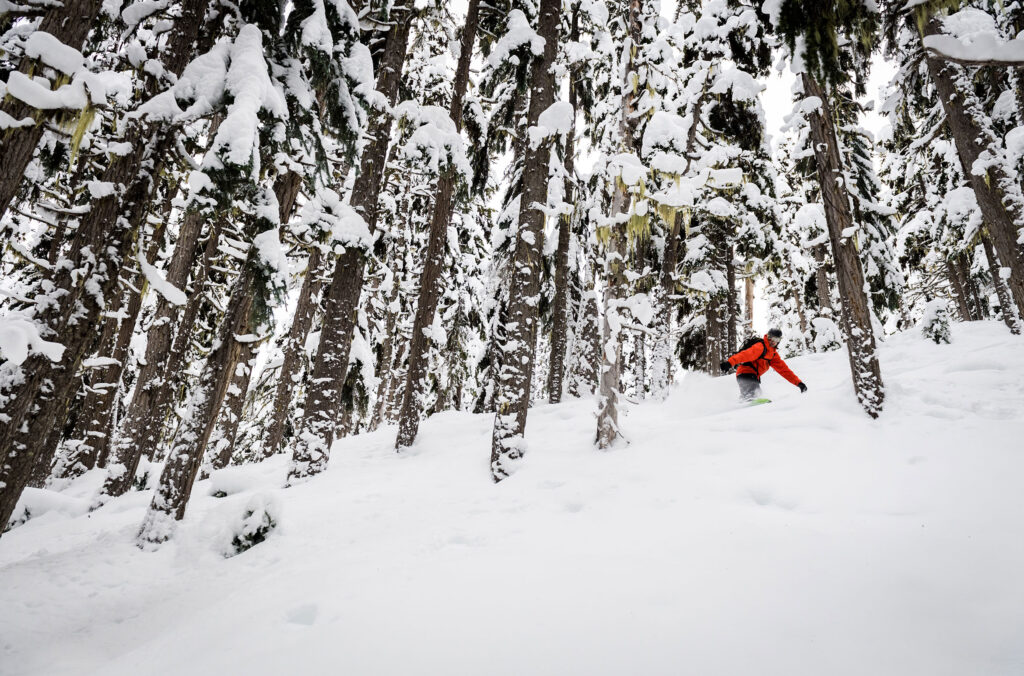A snowboarder makes their way through the powdery snow on Whistler Blackcomb.