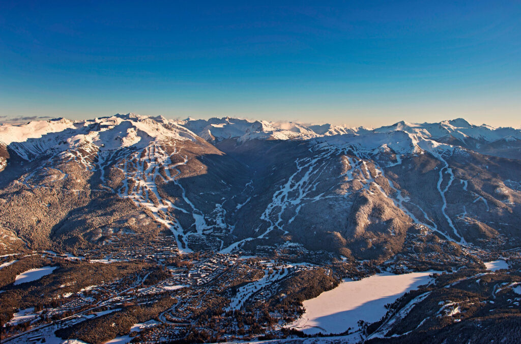 A stunning winter shot of Whistler Mountain and Blackcomb Mountain in the morning sunshine. 