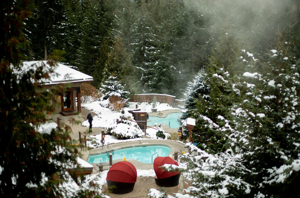 The hot pools at the Scandinave Spa Whistler send steam into the wintery air.
