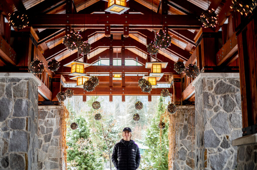 Ski athlete, Tonje Kvivik walks under the beautifully festive archway into Nita Lake Lodge.